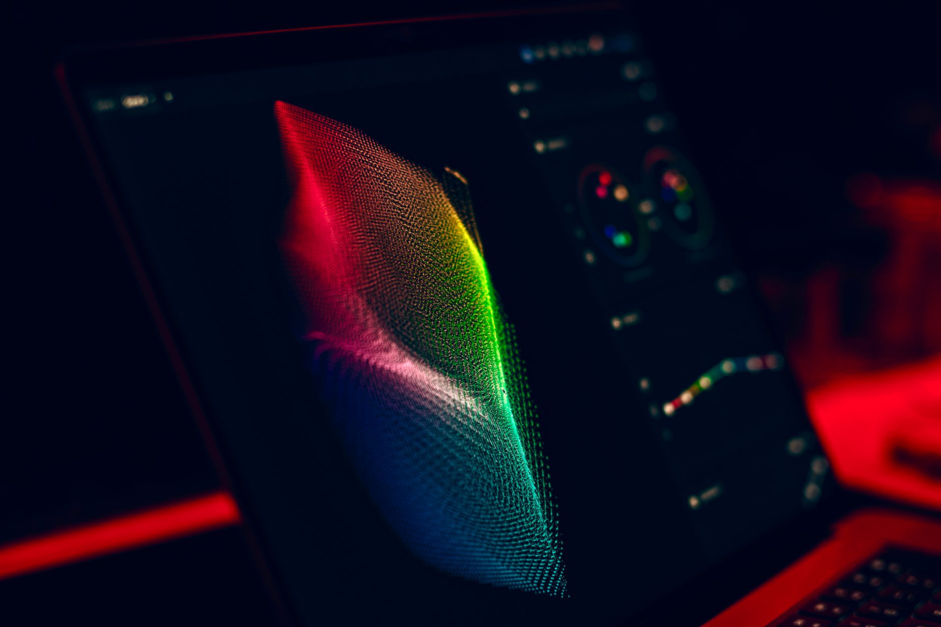 Close-up of vibrant digital art in red, green, and blue displayed on a monitor screen.
