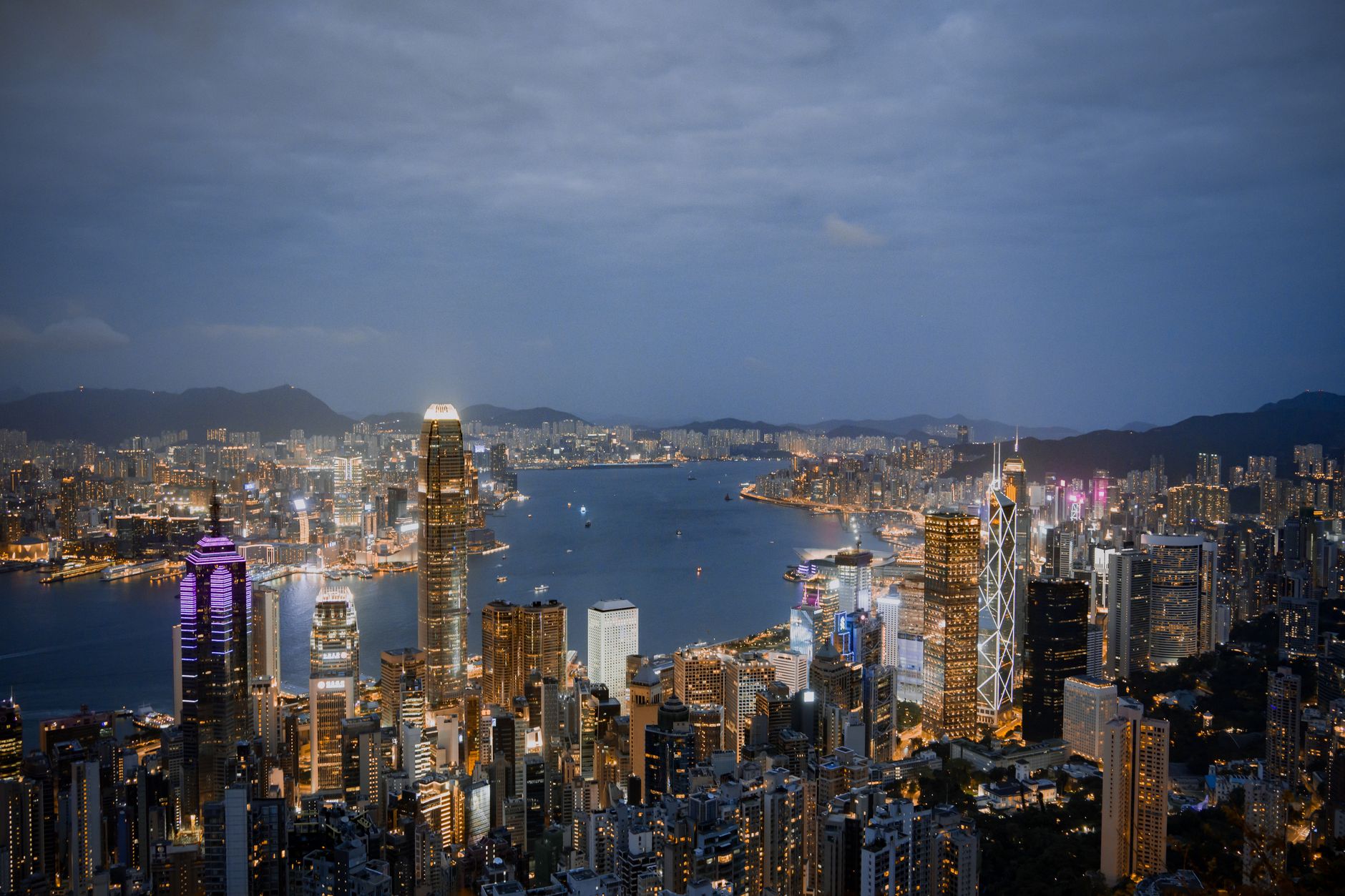 A breathtaking view of Hong Kong's illuminated skyline and harbor at night.