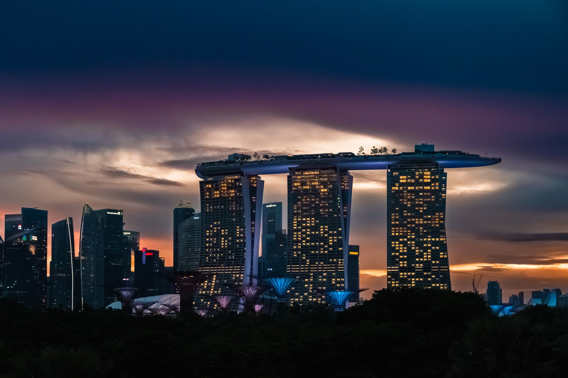 Dramatic skyline of Singapore with Marina Bay Sands at twilight.