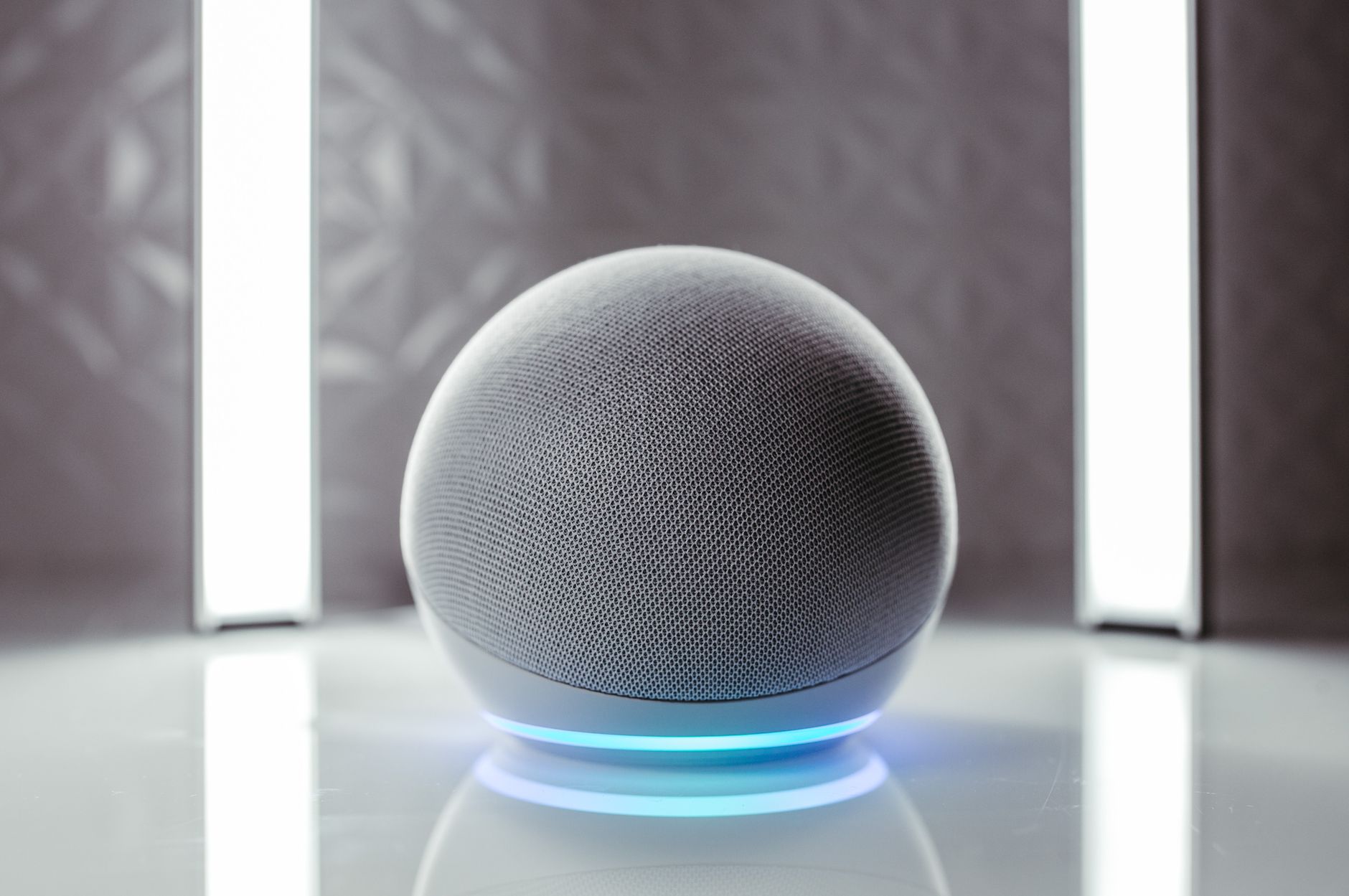 Close-up of a spherical smart speaker with illuminated base, perfect for modern interiors.