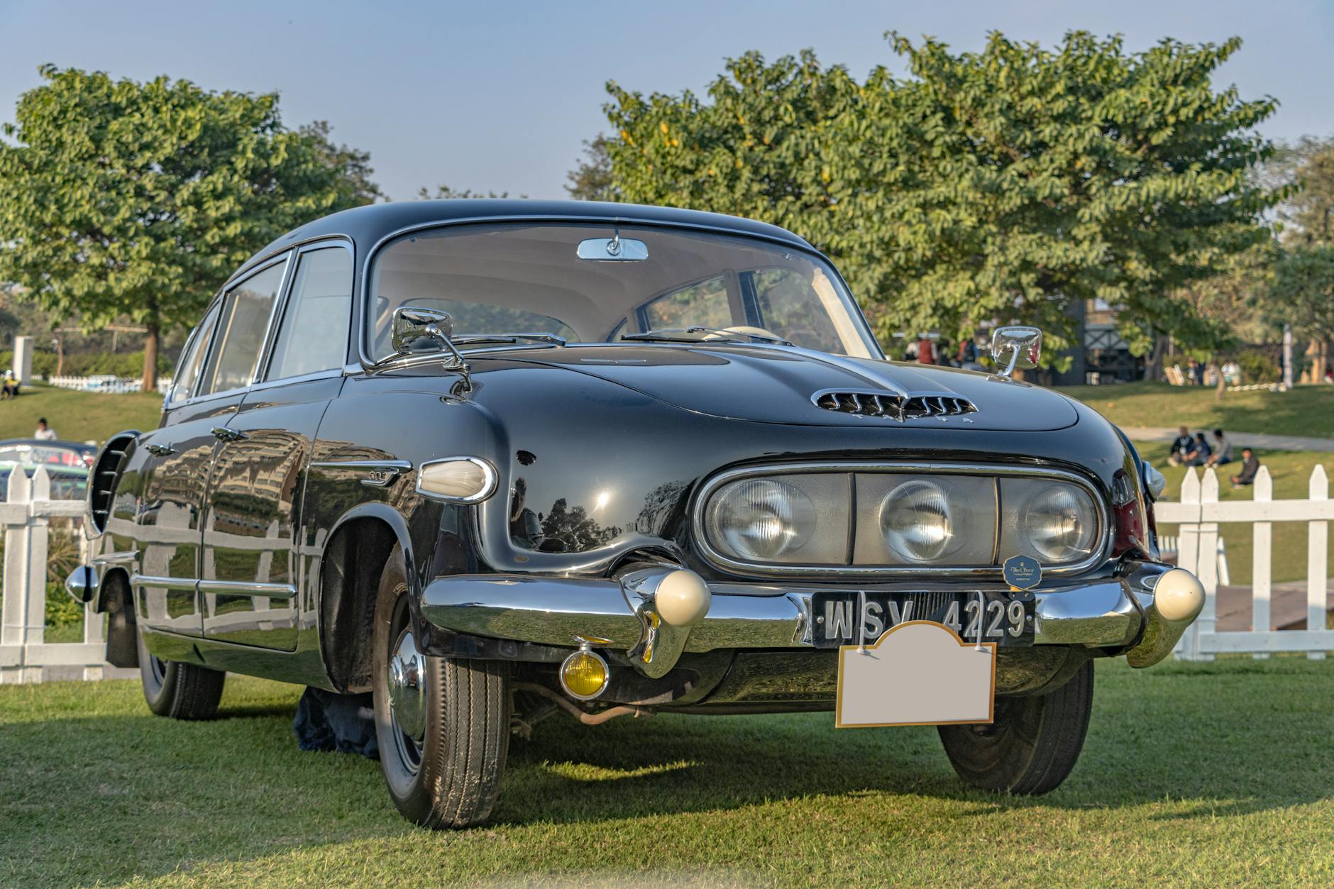 A stunning black Tatra 603 displayed at a car show in Gurugram, showcasing its vintage charm.