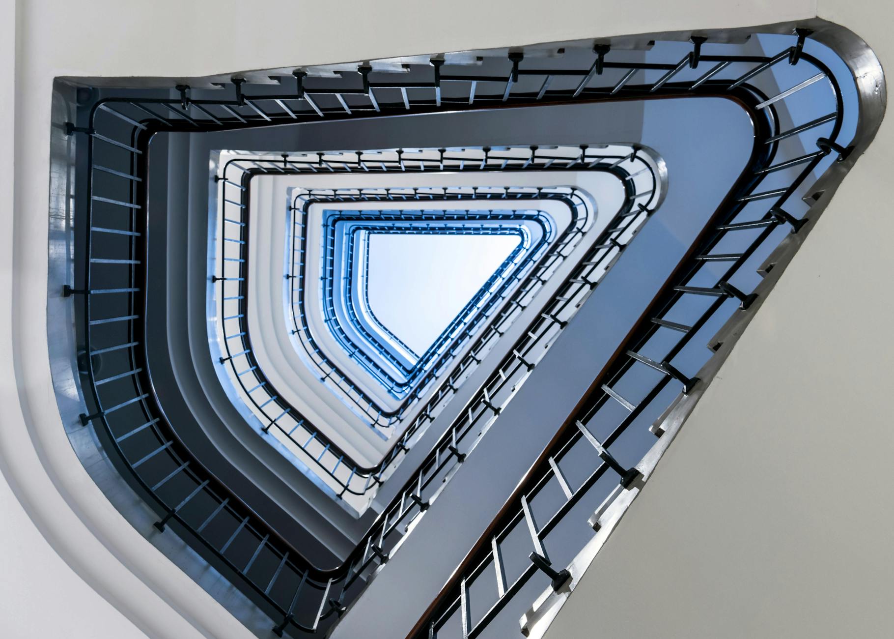 Abstract view of a triangular staircase with blue hues in Hamburg, Germany.