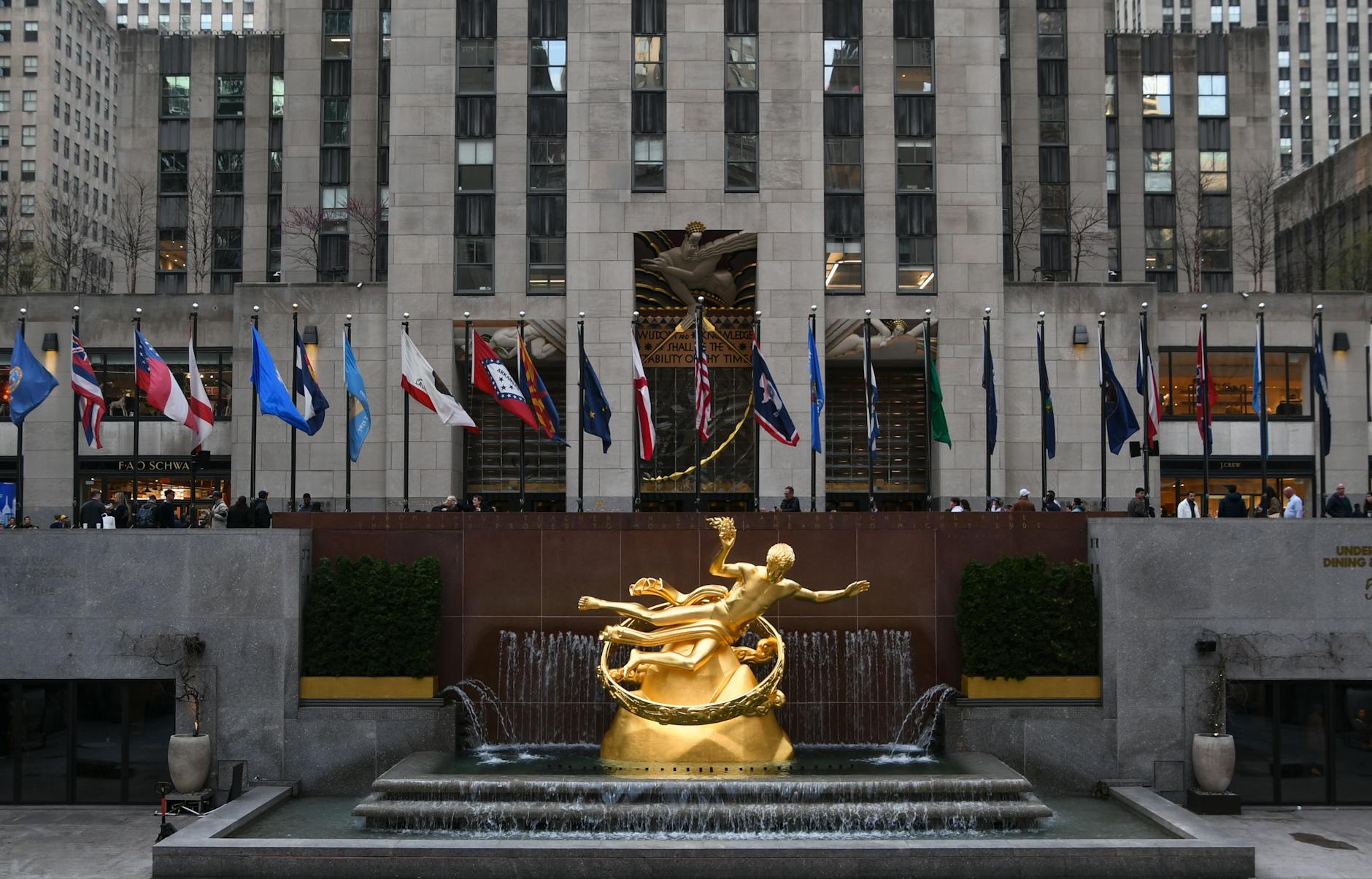 The iconic Prometheus statue surrounded by flags at Rockefeller Center, New York City.