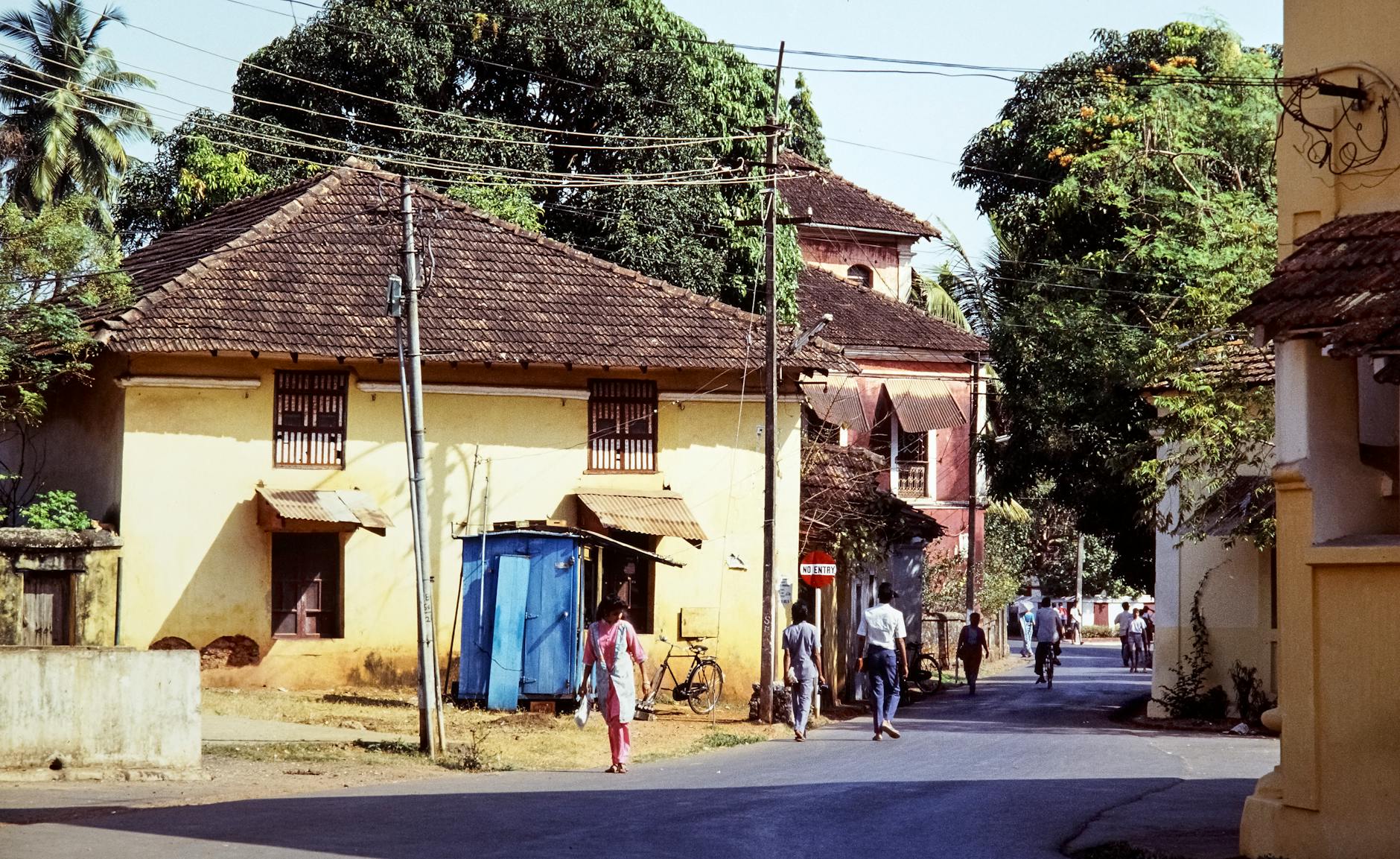 A vibrant street scene in Goa, India, featuring traditional architecture.
