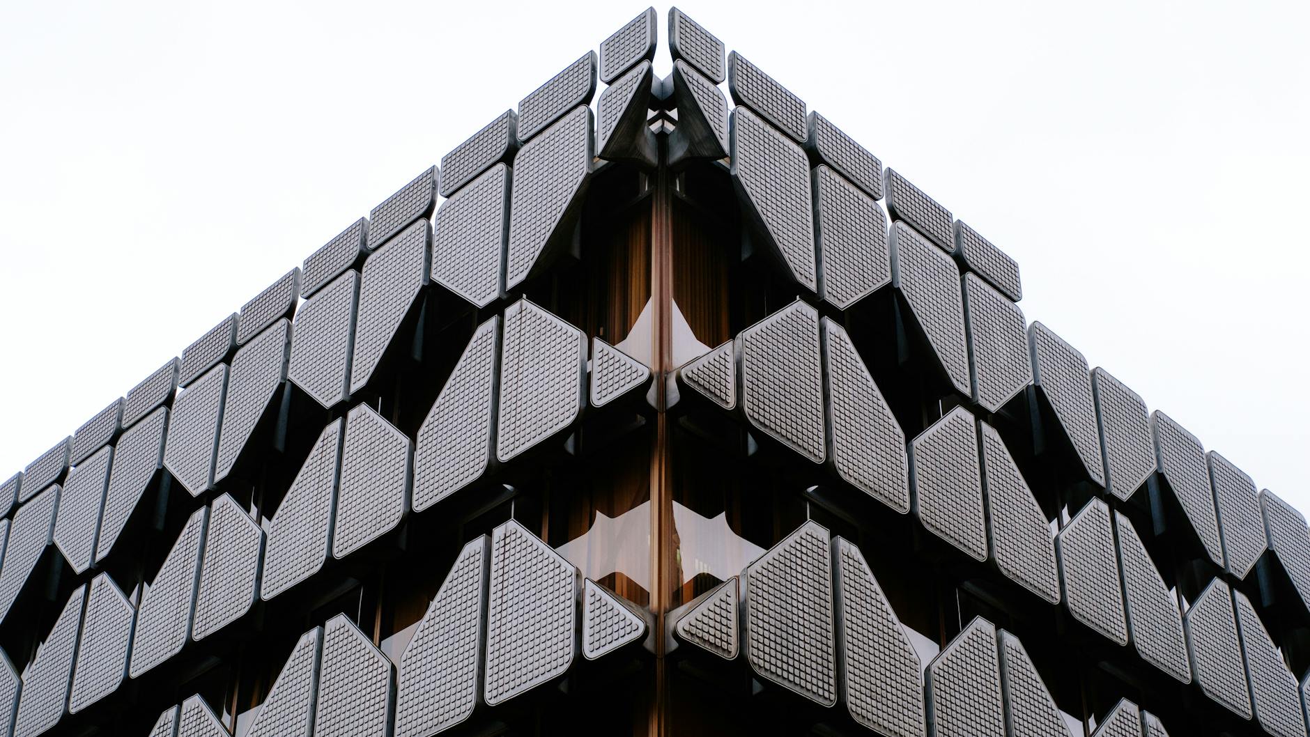 Close-up view of a futuristic modern facade with geometric design elements, showcasing urban architecture.
