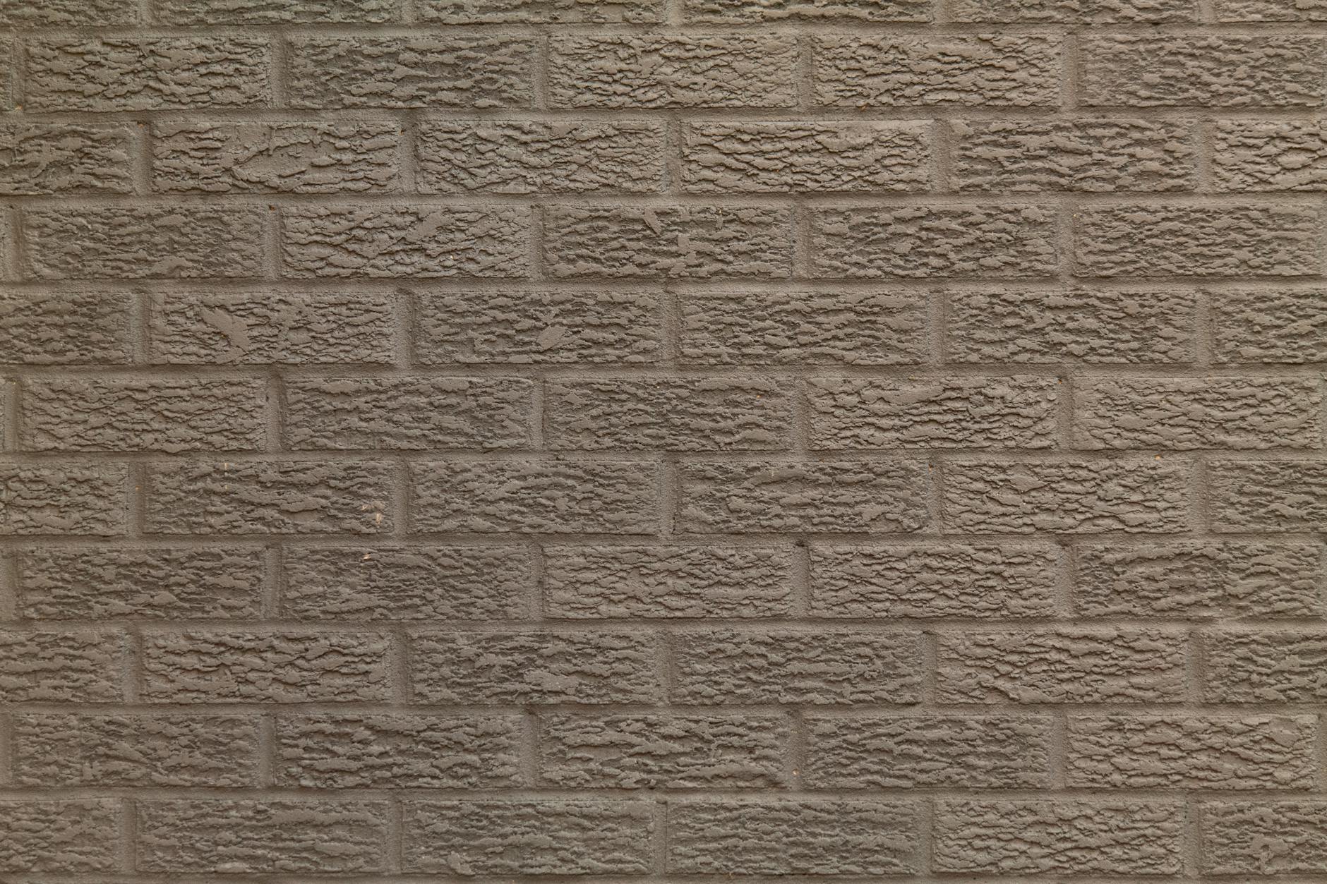 Close-up of a rough textured brick wall creating a pattern. Ideal for backgrounds.