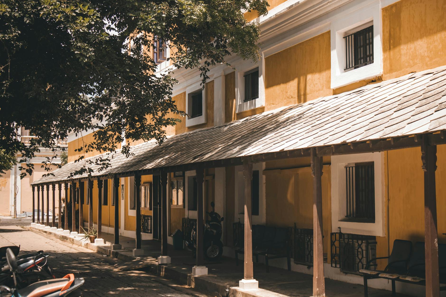 Explore the picturesque colonial architecture in Puducherry, India, with vibrant colors and historical elegance.
