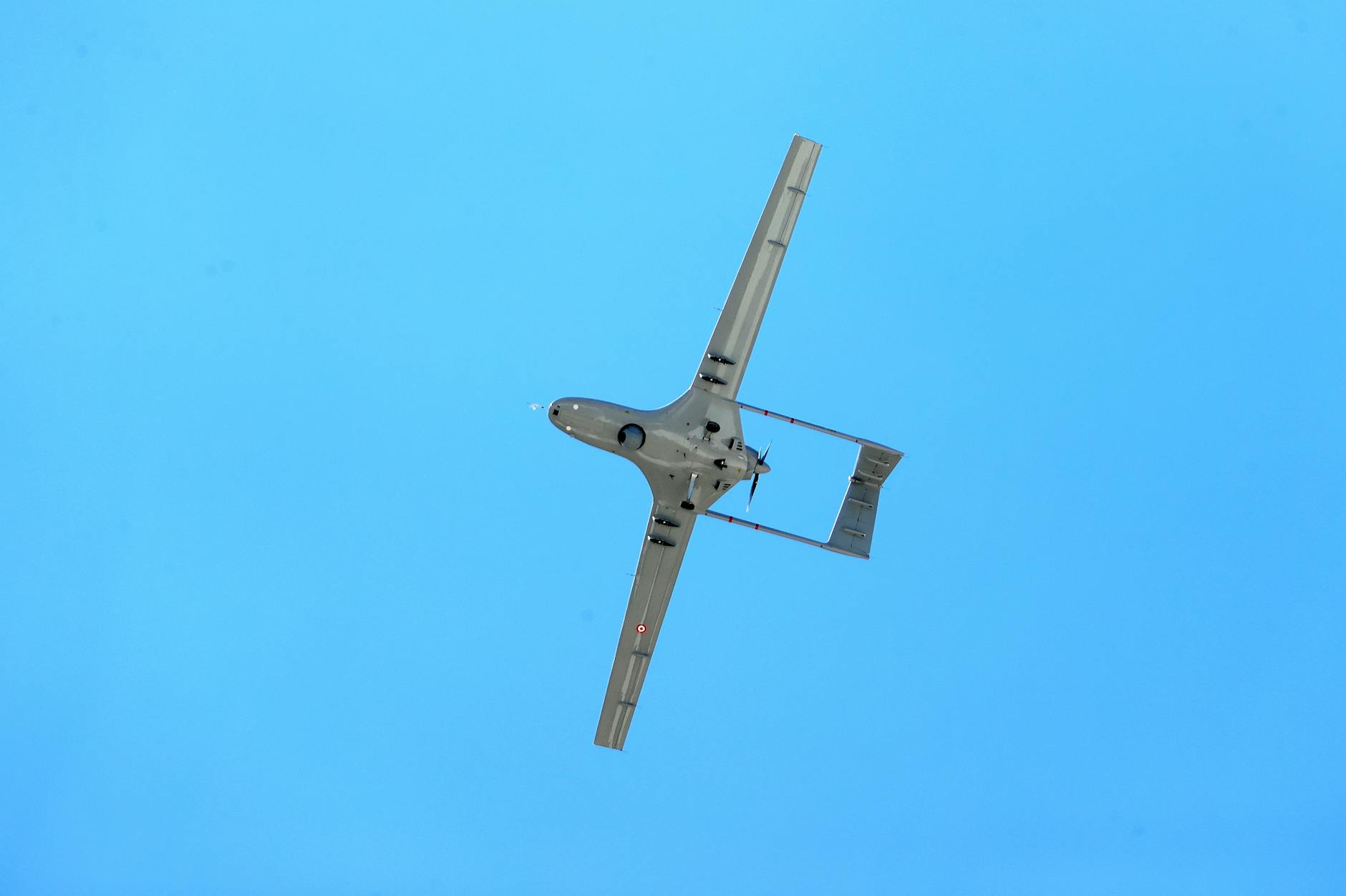 An aerial drone flying under a clear blue sky in Adana, Türkiye.