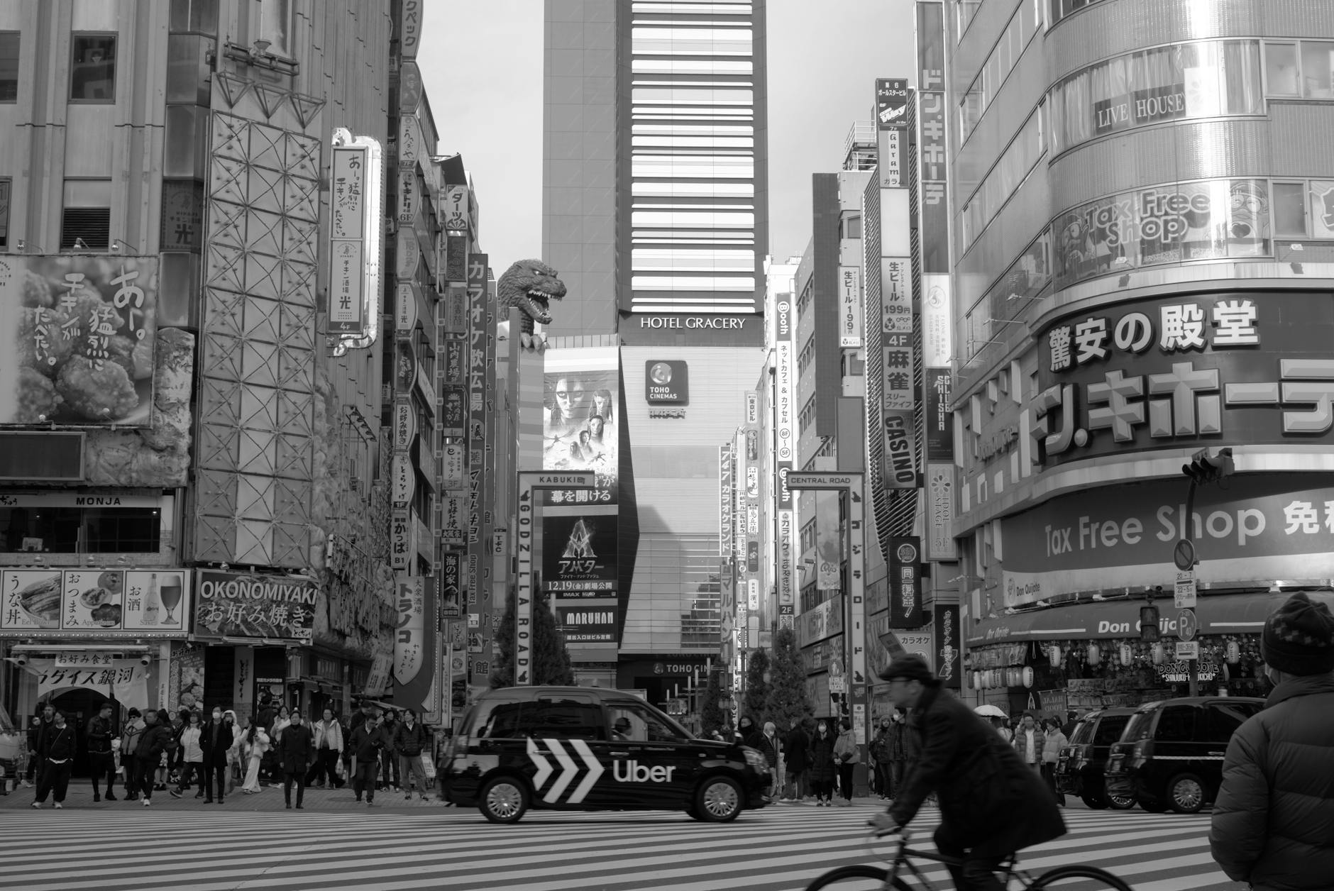 Lively street scene at Shinjuku, Tokyo with bustling pedestrians and city lights.