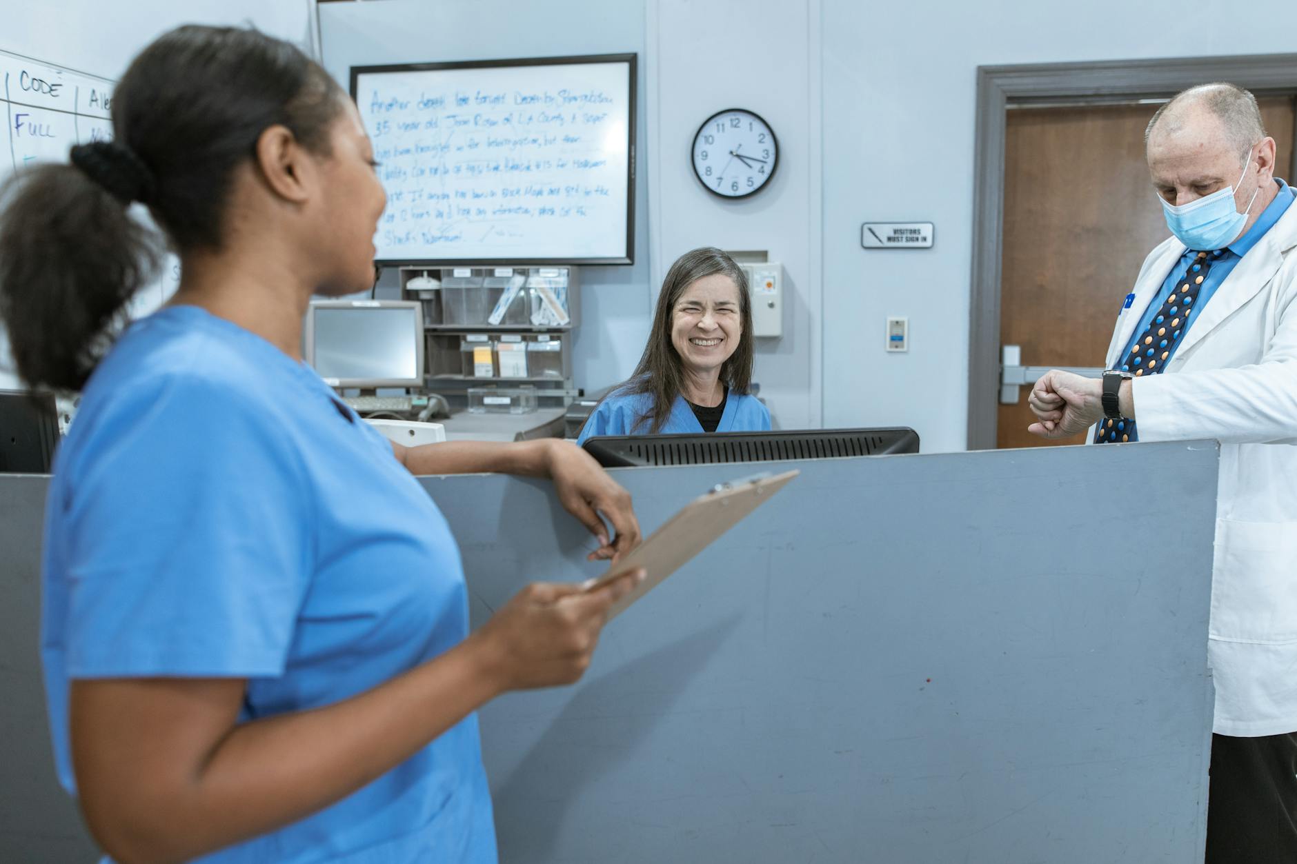 Doctors and nurses working together in a hospital, focused on patient care.