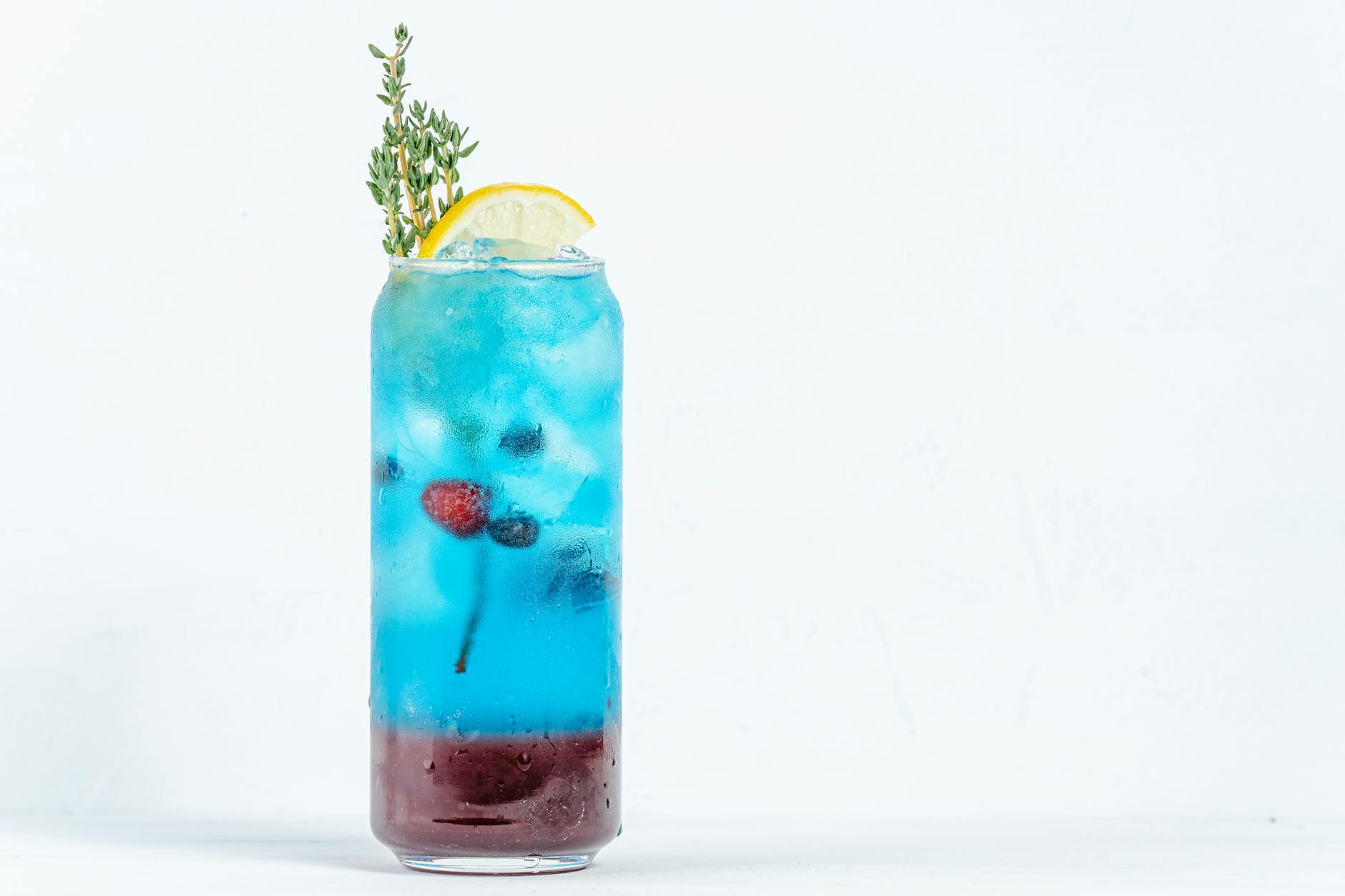 Vibrant blue cocktail with ice and lemon slice, perfect for a refreshing drink in Dubai.