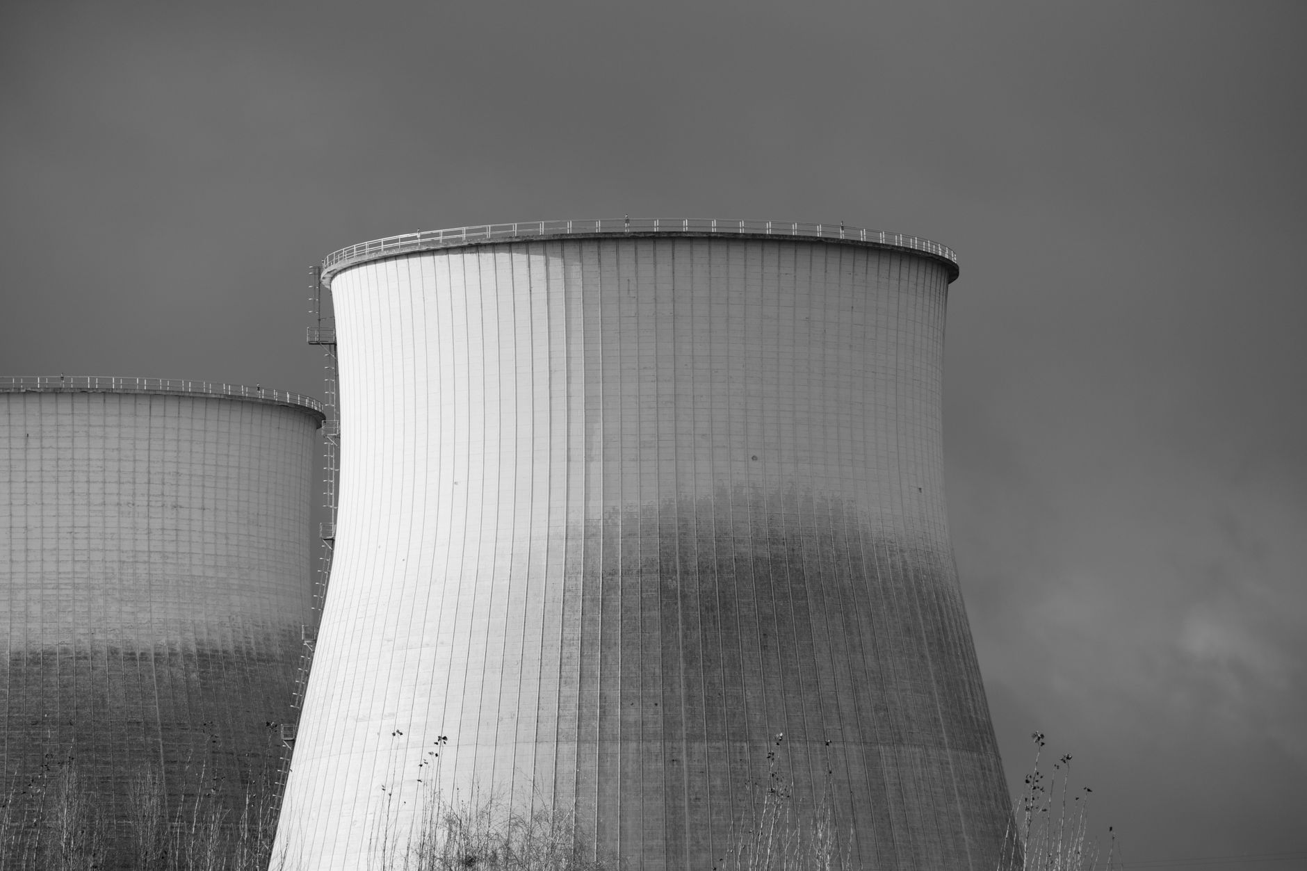 Elegant black and white depiction of cooling towers at a nuclear power station, symbolizing energy and industry.