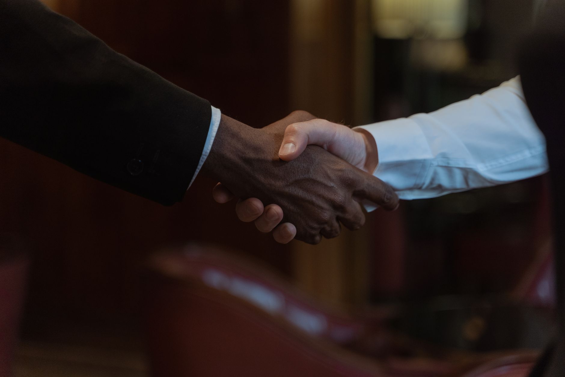 Close-up of a diverse handshake, representing business collaboration and diversity.