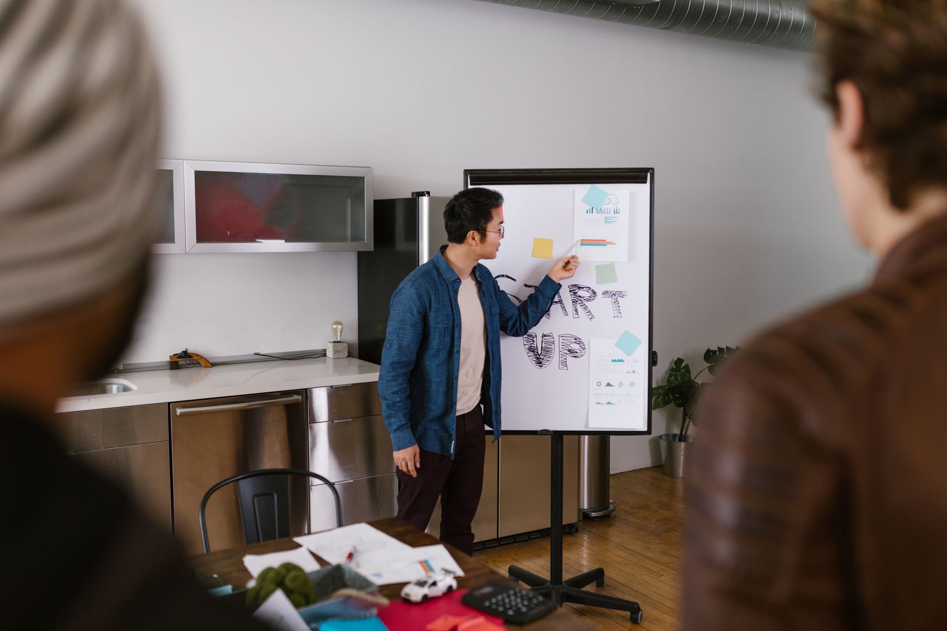 Team members discussing project ideas in a modern office setting.